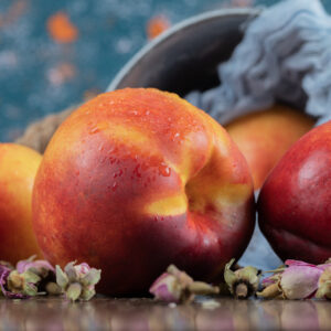 Yellow redish peaches on a piece of burlap on the table. High quality photo