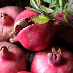 top view ripe pomegranates with a branch from a tree
